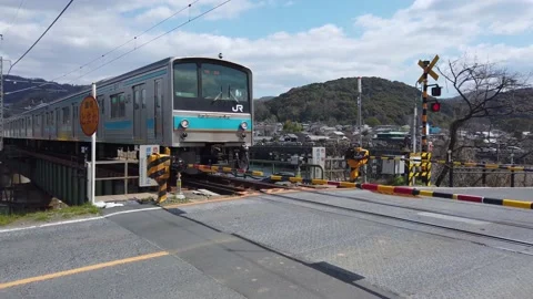 Japanese Train Passing Crossing at Uji River, Kyoto Japan Stock Footage 132019483
