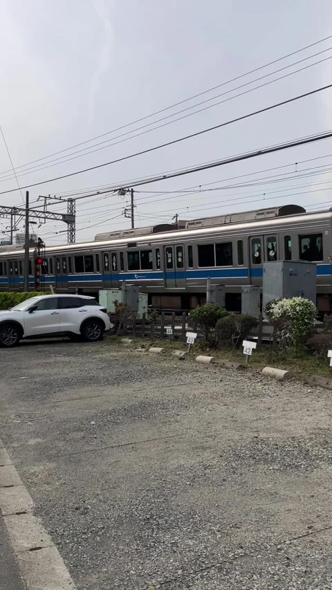 Japanese Train Passing by Level Crossing - Warning Bells and Clickety-Clack Stock Footage 331246737