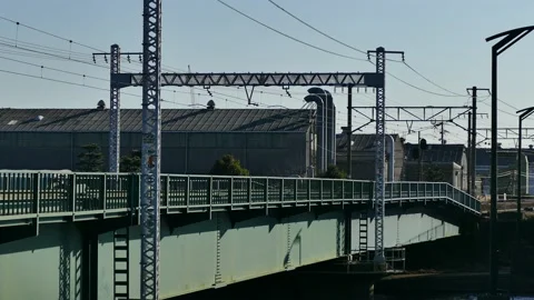 Japanese train passing over the sea and river, this is the Tokaido Line Stock Footage 124461663