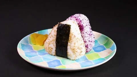 Japanese triangular rice balls on a plate, rotating Stock Footage 307076243