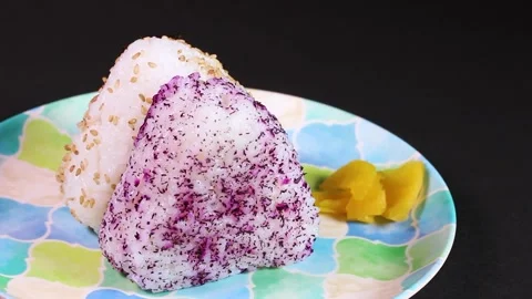 Japanese triangular rice balls on a plate, rotating Stock Footage 307076244