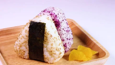 Japanese triangular rice balls on a plate, rotating Stock Footage 307076369