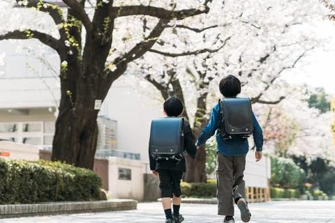 Japanese upper elementary school students and first graders holding hands Stock Photos