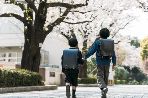 Japanese upper elementary school students and first graders holding hands Stock Photos