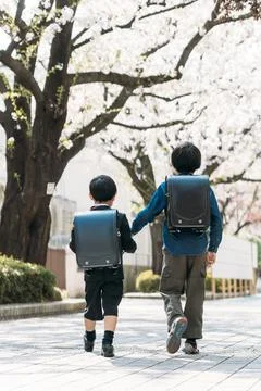 Japanese upper elementary school students and first graders holding hands Stock Photos