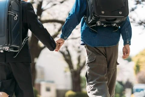 Japanese upper elementary school students and first graders holding hands Stock Photos