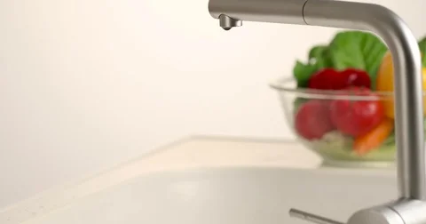 Japanese woman washing vegetables in the kitchen Stock Footage