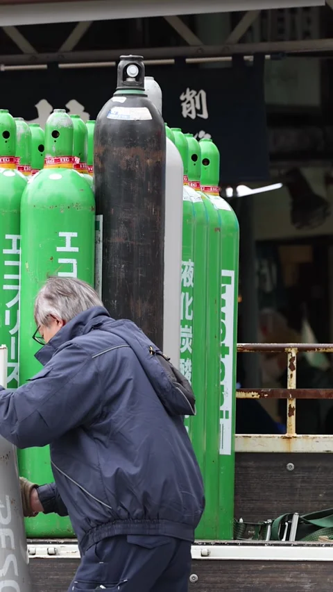 Japanese Worker Loading Industrial Gas Cylinders Onto Delivery Truck Stock Footage 343837519