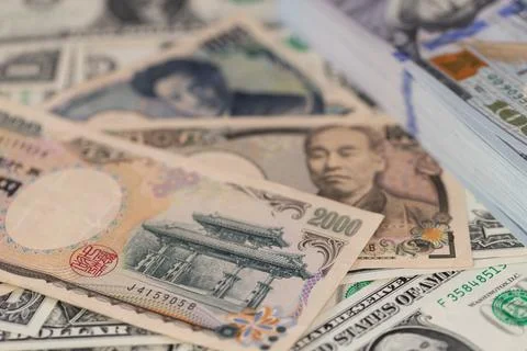 Japanese yen banknotes and stack of US dollars in global currency exchange .. 스톡 사진