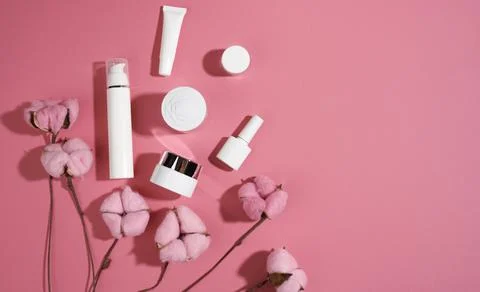 Jar and empty white plastic tubes for cosmetics on a pink background. Packagi Stock Photos