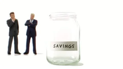 A jar being filled with coins Stock Footage 11285559