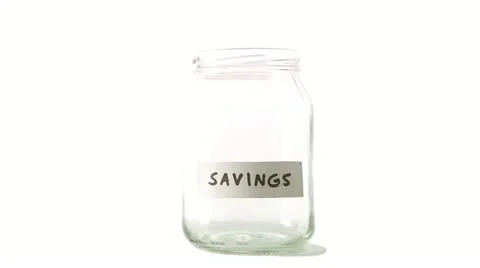 A jar being filled with coins Stock Footage 11285563