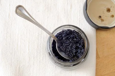 Jar of black lumpfish eggs on the table Stock Photos