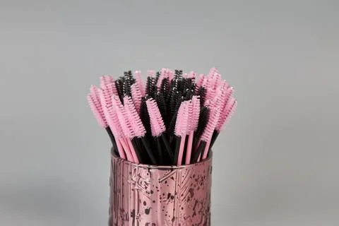 A jar with brushes for eyelashes on a gray background Stock Photos