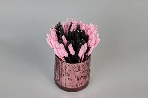 A jar with brushes for eyelashes on a gray background Stock Photos