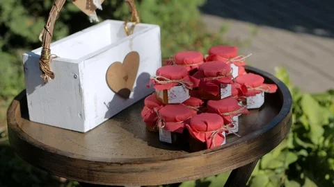 A jar with candles inside, on the table next to the money box Stock Footage 127832681