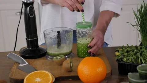 A jar with a cocktail of fruit and sprouted wheat sprouts on a wooden table. Stock Footage 150266840