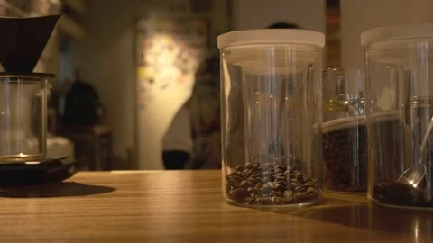 A jar of coffee beans and a pour over brewer in a cafe 動画素材 234483863