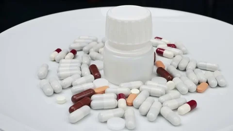 Jar with colored pills rotating Stock Footage 81261596