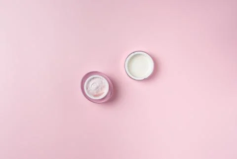 Jar of cream isolated on pink background, top view Stock Photos