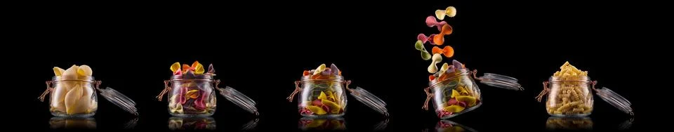 Jar of different type of pasta isolated on black background Illustrazione stock
