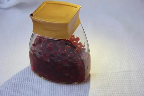 Jar with an elixir or tincture with cranberry berries on a white background, a Stock Photos