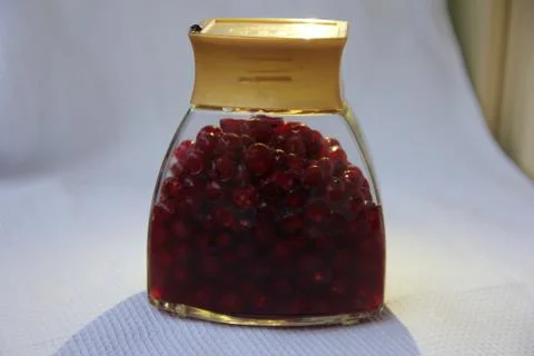 Jar with an elixir or tincture with cranberry berries on a white background, a Stock Photos