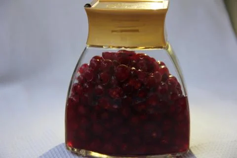 Jar with an elixir or tincture with cranberry berries on a white background, a Stock Photos