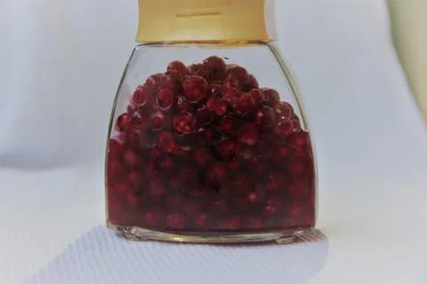 Jar with an elixir or tincture with cranberry berries on a white background, a Stock Photos