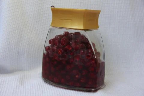 Jar with an elixir or tincture with cranberry berries on a white background, a Stock Photos
