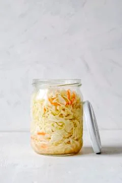 Jar of fermented cabbage on white background Stock Photos