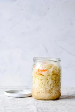 Jar of fermented cabbage on white background Stock Photos