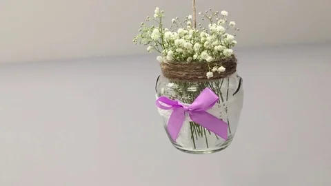 Jar with flowers hanging Stock Footage 78784432
