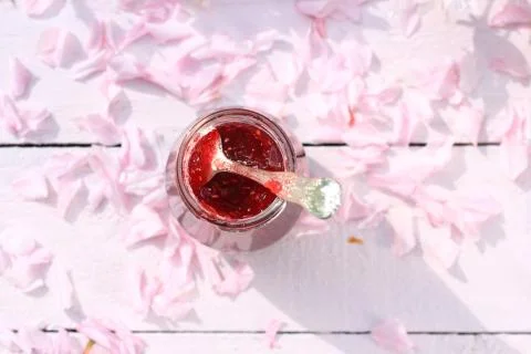 A jar of fresh raspberry jam on light rustic background, close up, in the gar Stock Photos