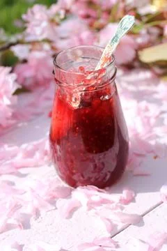 A jar of fresh raspberry jam on light rustic background, close up, in the gar Stock Photos