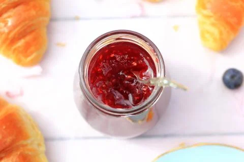 A jar of fresh raspberry jam on light rustic background, close up, in the gar Stock Photos