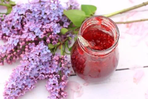 A jar of fresh raspberry jam on light rustic background, close up, in the gar Stock Photos