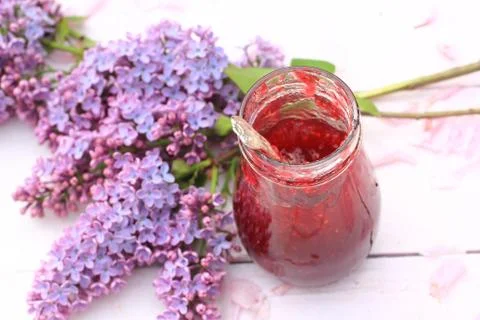 A jar of fresh raspberry jam on light rustic background, close up, in the gar Stock Photos