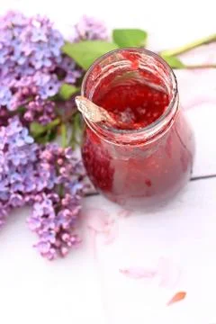 A jar of fresh raspberry jam on light rustic background, close up, in the gar Stock Photos