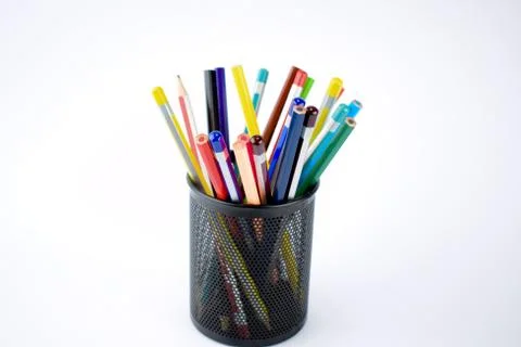 Jar full of different colored pencils and crayons on a white background Foto stock