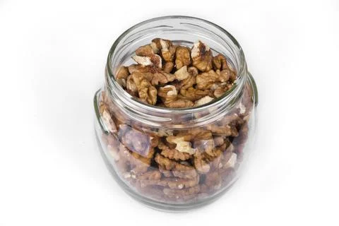 Jar full of walnuts on a white background Stock Photos