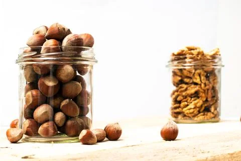 Jar of hazelnuts Stock Photos