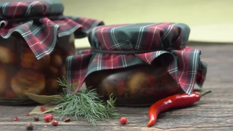 A jar of marinated champignons is placed on the table Stock Footage 296581776