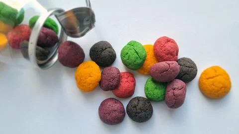 Jar with metal pull-tab lid and colorful cookies on a white background Stock Photos