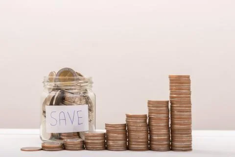 Jar with money stack step growing growth saving money with gray background,.S Stock Photos