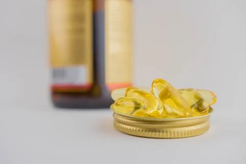 Jar with omega 3 capsules in a cap on a white background Stock Photos