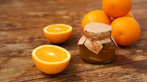 Jar of orange jam on wooden background from top view. Homemade marmalade Stock Photos