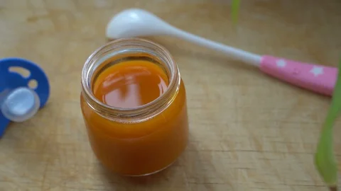 Jar of orange puree stands open Stock Footage 124211095