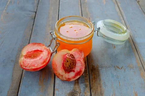 Jar with peach jam on the rustic table Stock Photos