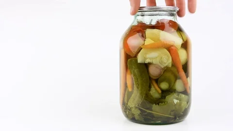 Jar with pickled vegetables, white background rotates to show contents, closeup Video stock 105104002
